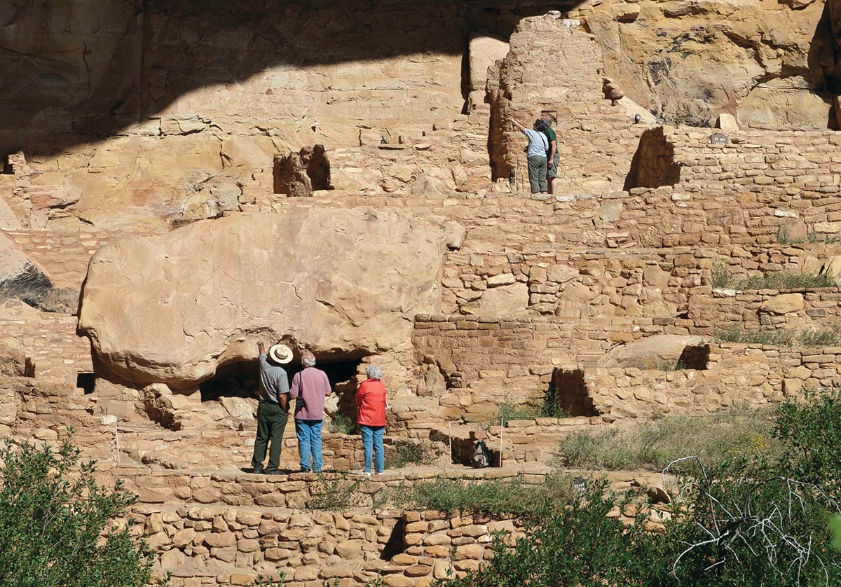 Park visitors visiting a cliff dwelling