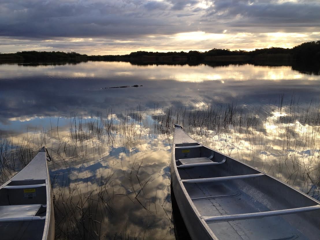 Two canoes at Nine Mile Pond during sunset.