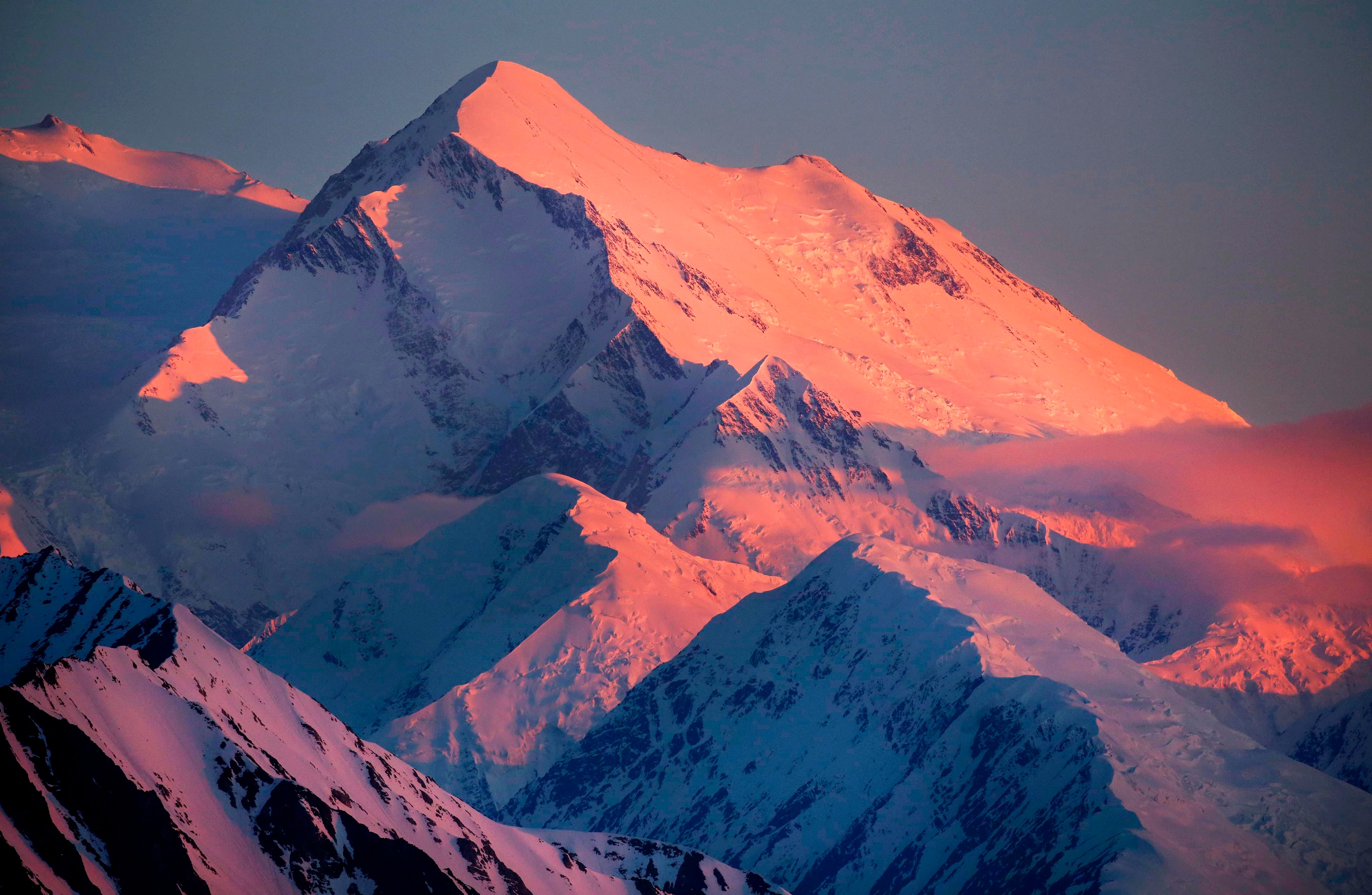 light turns a snowy mountain shades of pink and purple